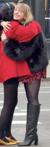 plush black fur coat and sheer black tights